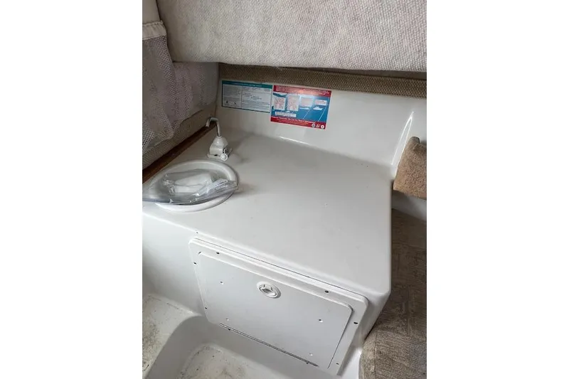 Slide: The Image of 2004 Seaswirl Striper 2601 Walkaround I/O cabin interior with sink and storage. - 4