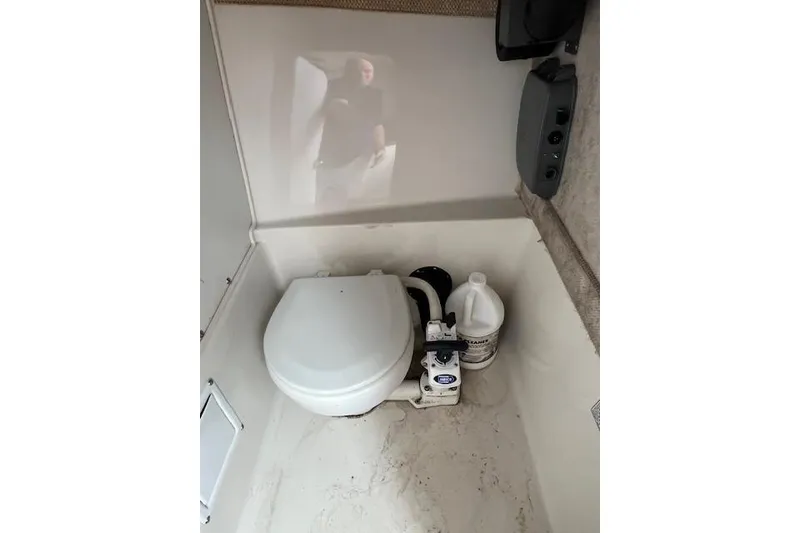 Slide: The Image of 2004 Seaswirl Striper 2601 Walkaround I/O boat interior with toilet and cleaning supplies. - 5