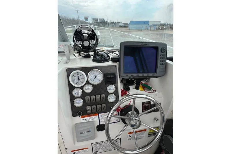 Slide: The Image of 2004 Seaswirl Striper 2601 Walkaround I/O dashboard with gauges, steering wheel, and navigation equipment. - 6