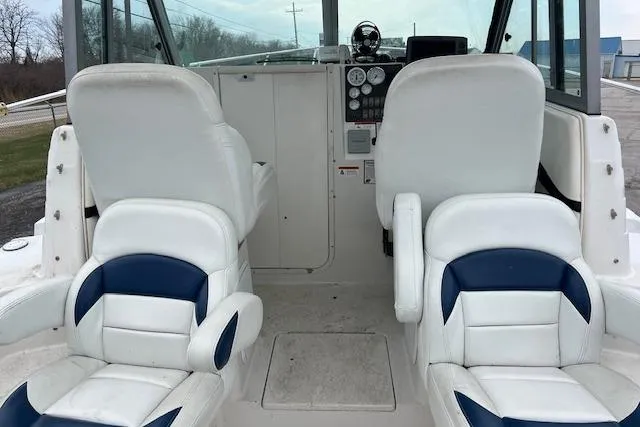 Slide: The Image of 2004 Seaswirl Striper 2601 Walkaround I/O boat interior with white and blue seating. - 9