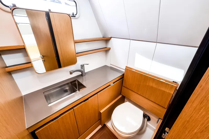 Slide: The Image of Modern bathroom interior of Aiata Wayfinder 38 Open yacht, featuring sleek wood cabinetry, 2025 model. - 20