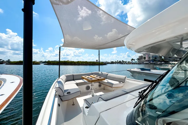 Slide: The Image of 2025 Aiata Wayfinder 38 Open boat with shaded seating area on a sunny day. - 22