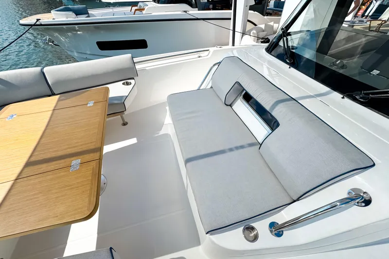 Slide: The Image of 2025 Aiata Wayfinder 38 Open yacht interior with cushioned seating and wooden table. - 24