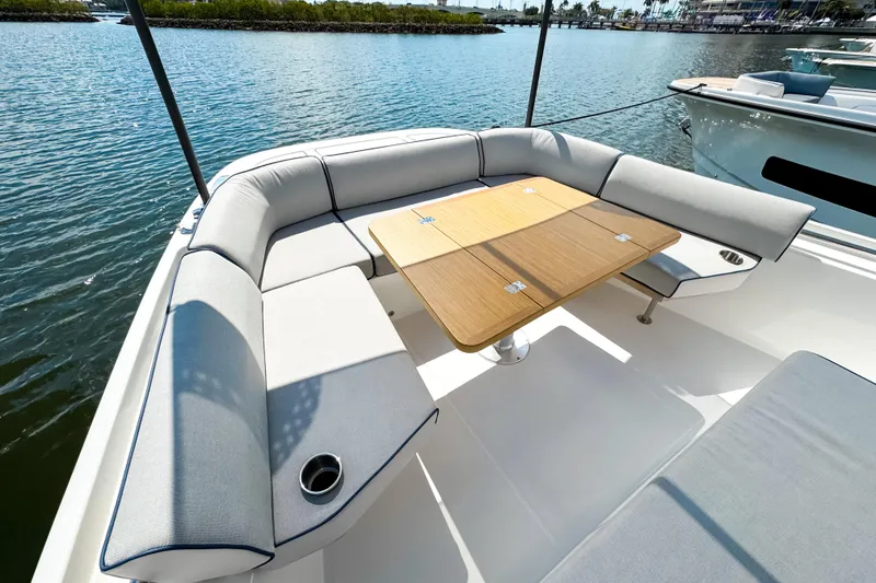 Slide: The Image of Luxurious seating area on the 2025 Aiata Wayfinder 38 Open yacht, featuring a wooden table. - 25