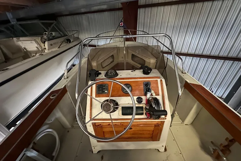 The Image of 1978 Boston Whaler Outrage 20 boat interior with steering wheel and control panel. - 0