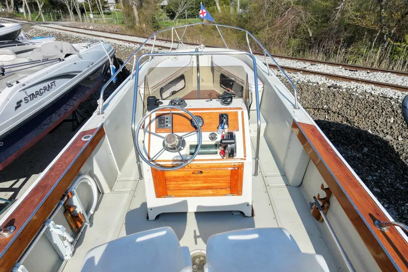 Slide: The Image of 1978 Boston Whaler Outrage 20 boat interior with wooden console and steering wheel. - 11