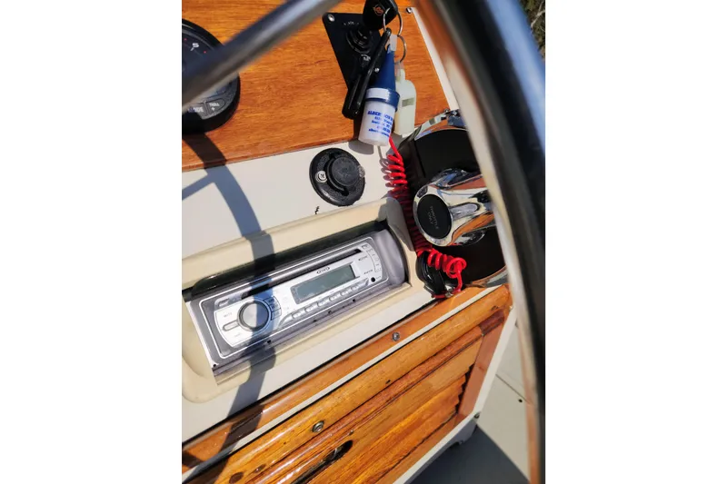 Slide: The Image of 1978 Boston Whaler Outrage 20 dashboard with radio and wooden accents. - 13