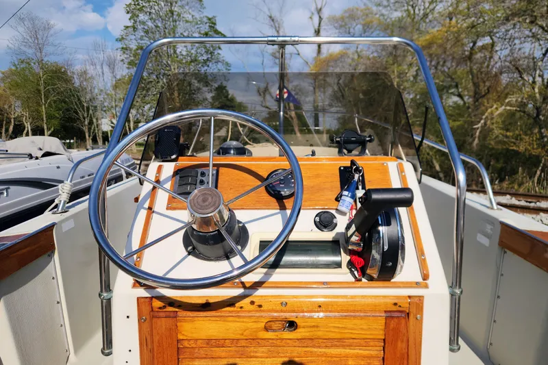 Slide: The Image of 1978 Boston Whaler Outrage 20 boat helm with wooden accents and steering wheel. - 14