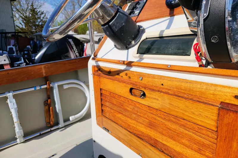 Slide: The Image of 1978 Boston Whaler Outrage 20 boat dashboard with wooden accents and steering wheel. - 15