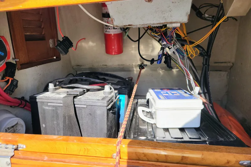 Slide: The Image of 1978 Boston Whaler Outrage 20 boat interior showing battery and wiring setup. - 18