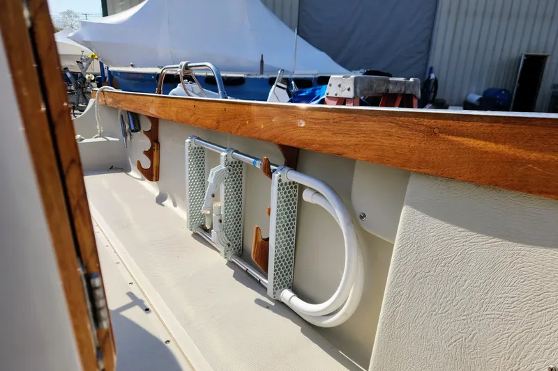 Slide: The Image of 1978 Boston Whaler Outrage 20 interior with wooden trim and mounted equipment. - 19