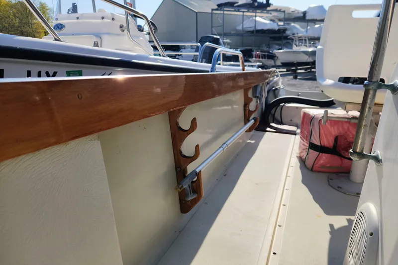 Slide: The Image of 1978 Boston Whaler Outrage 20 interior with wooden trim and seating. - 20