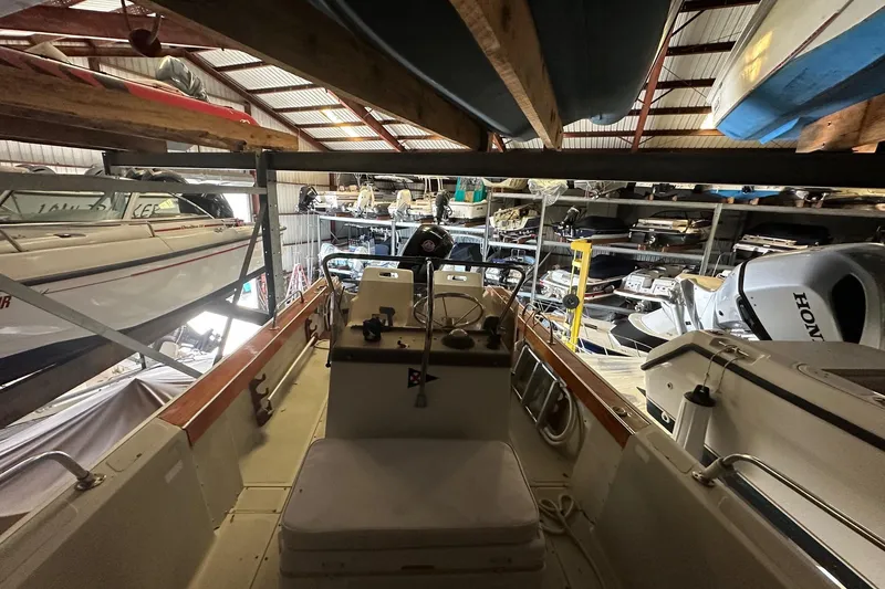 Slide: The Image of 1978 Boston Whaler Outrage 20 stored in a boat warehouse with other vessels. - 5