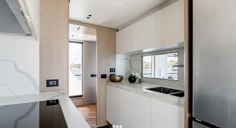 Slide: The Image of Modern kitchen interior of 2025 Azimut Grande 26M yacht, featuring sleek design and appliances. - 16