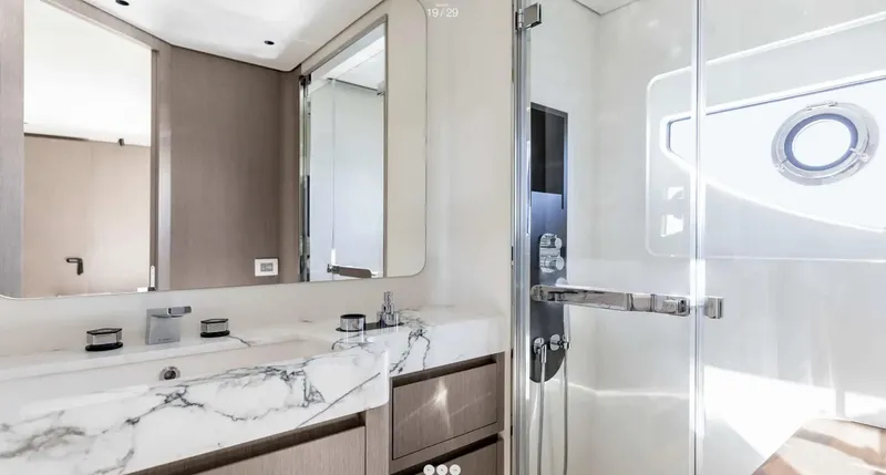 Slide: The Image of Luxurious bathroom in 2025 Azimut Grande 26M yacht with marble countertop and glass shower. - 22