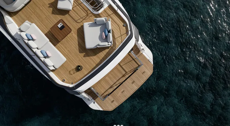Slide: The Image of Azimut Grande 26M 2025 yacht deck with luxurious seating over clear blue water. - 5