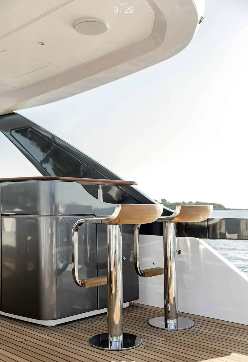 Slide: The Image of Luxury Azimut Grande 26M yacht deck with modern bar stools, 2025 model. - 8