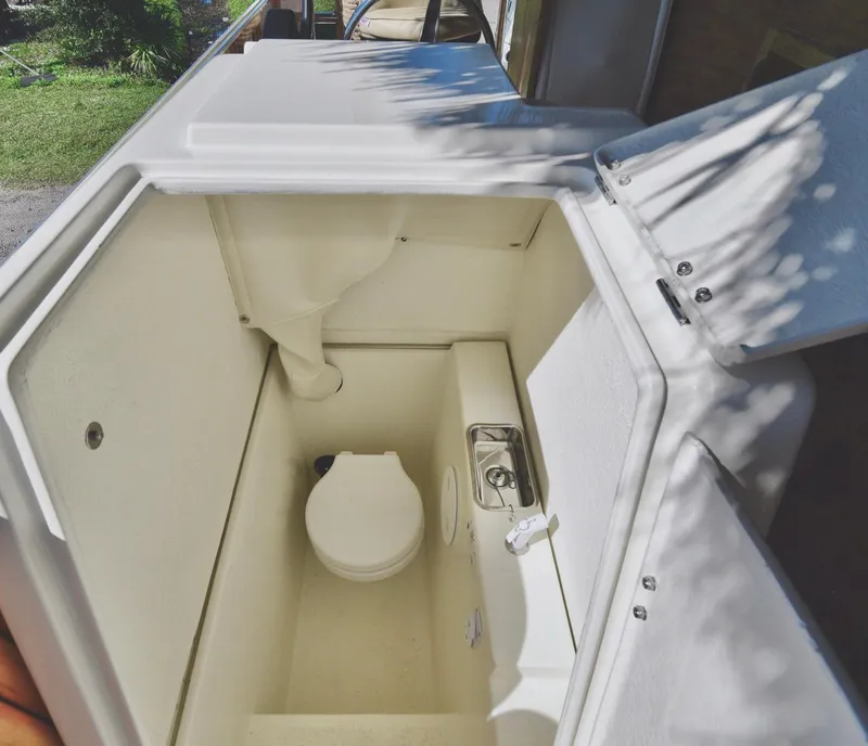 Slide: The Image of 2023 Beachcat 23 Catamaran interior with compact marine toilet and sink. - 12