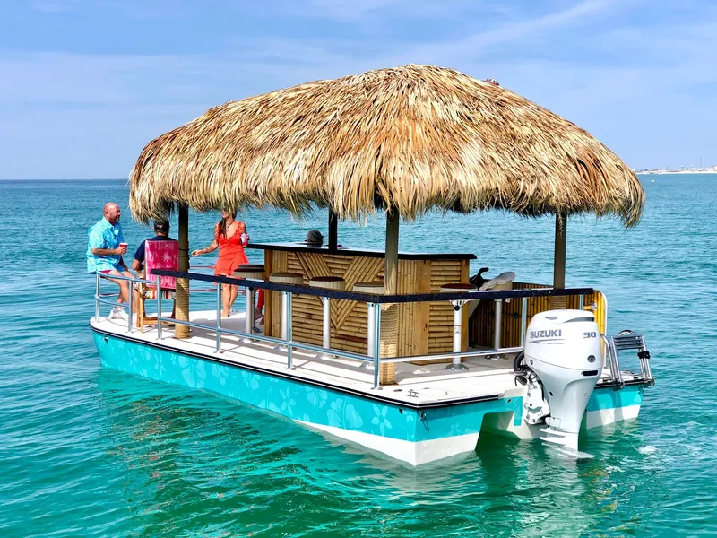 Slide: The Image of 2023 Beachcat 23 Catamaran with tiki hut, cruising on clear blue water. - 3