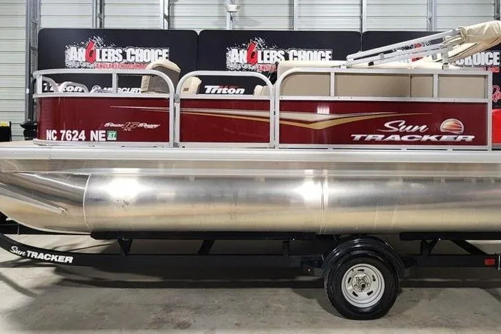 The Image of 2025 Sun Tracker Bass Buggy 16 XL Select pontoon boat in showroom, side view. - 0