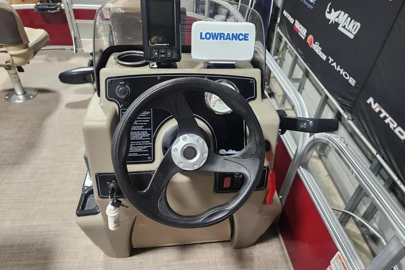 Slide: The Image of Steering console of 2025 Sun Tracker Bass Buggy 16 XL Select with Lowrance electronics. - 5