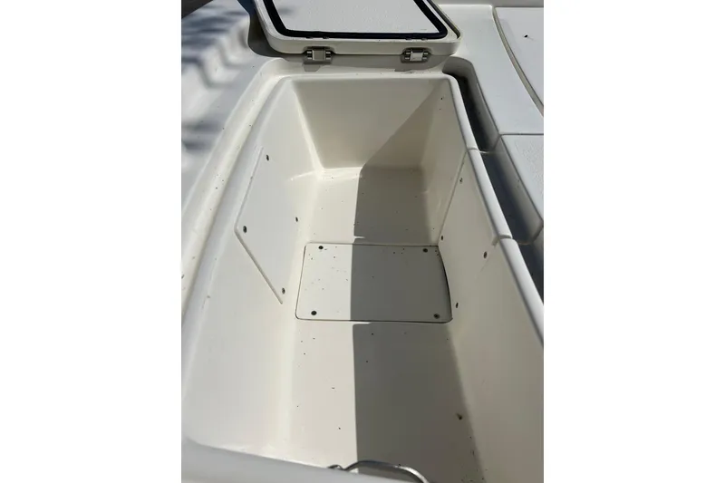 Slide: The Image of Open storage compartment on 2025 Mako Pro Skiff 13 CC boat. - 3