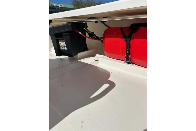 Slide: The Image of 2025 Mako Pro Skiff 13 CC boat interior with battery and red fuel tank. - 4