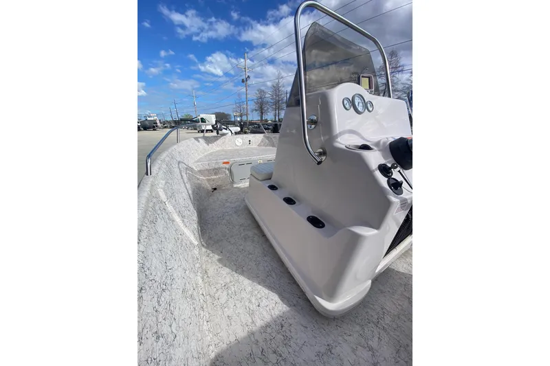 Slide: The Image of 2001 Fishmaster 17 boat with center console, under a clear blue sky. - 14