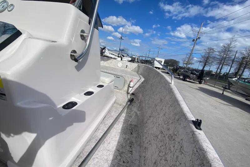 Slide: The Image of 2001 Fishmaster 17 boat interior with clear sky and parked boats in background. - 15