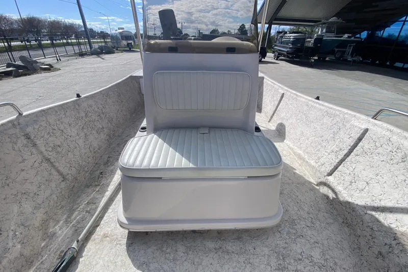 Slide: The Image of 2001 Fishmaster 17 boat interior with cushioned seating under a sunny sky. - 18