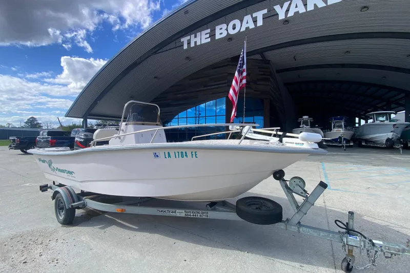 Slide: The Image of 2001 Fishmaster 17 boat on trailer outside The Boat Yard, with American flag. - 2