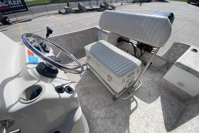 Slide: The Image of 2001 Fishmaster 17 boat interior with steering wheel and cushioned seating. - 21