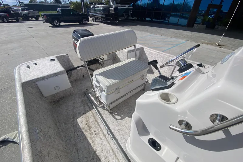 Slide: The Image of 2001 Fishmaster 17 boat interior with steering console and seating in a parking area. - 22