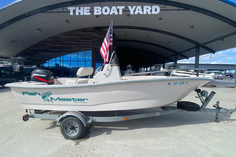 Slide: The Image of 2001 Fishmaster 17 boat with trailer at The Boat Yard, featuring a Mercury engine. - 3
