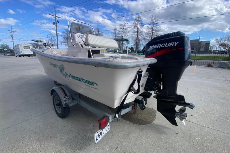 Slide: The Image of 2001 Fishmaster 17 boat with Mercury outboard motor on a trailer. - 6
