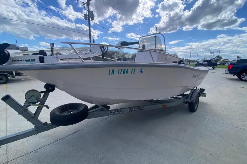 Slide: The Image of 2001 Fishmaster 17 boat on trailer under cloudy sky, parked in lot. - 8