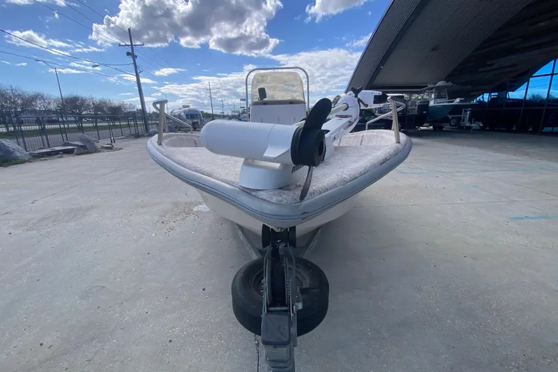 Slide: The Image of 2001 Fishmaster 17 boat on trailer under cloudy sky, front view. - 9