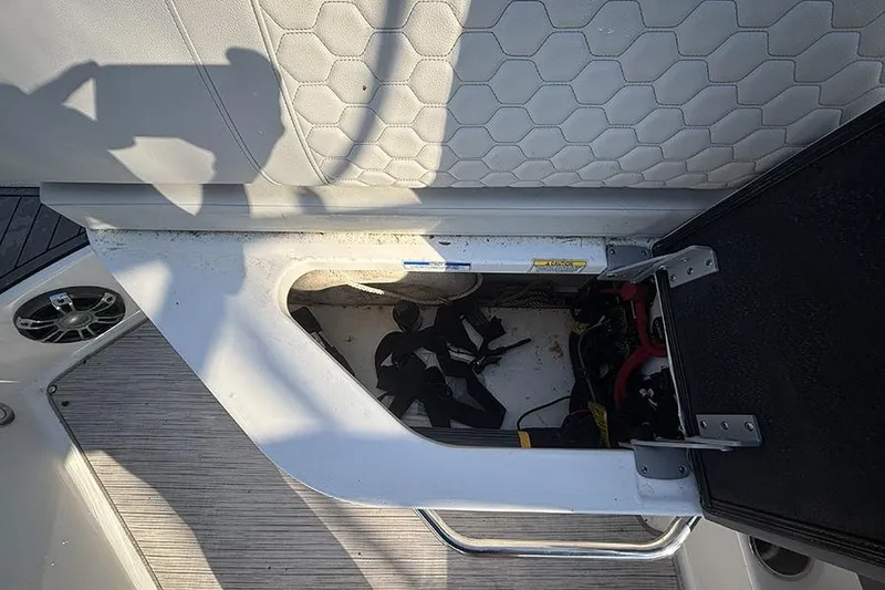 Slide: The Image of Storage compartment on a 2021 Sea Ray SDX 270 Outboard boat, featuring interior equipment. - 15