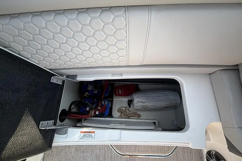 Slide: The Image of Storage compartment in 2021 Sea Ray SDX 270 Outboard boat with safety equipment. - 16