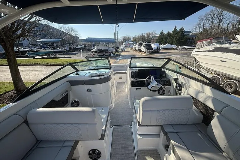 Slide: The Image of 2021 Sea Ray SDX 270 Outboard boat interior with seating and steering wheel. - 17