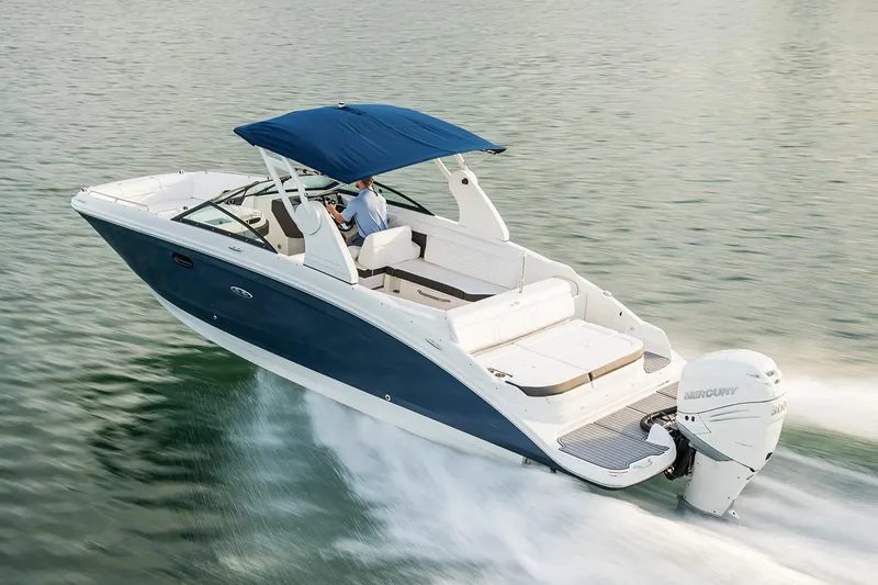 Slide: The Image of 2021 Sea Ray SDX 270 Outboard boat on trailer under clear blue sky. - 2