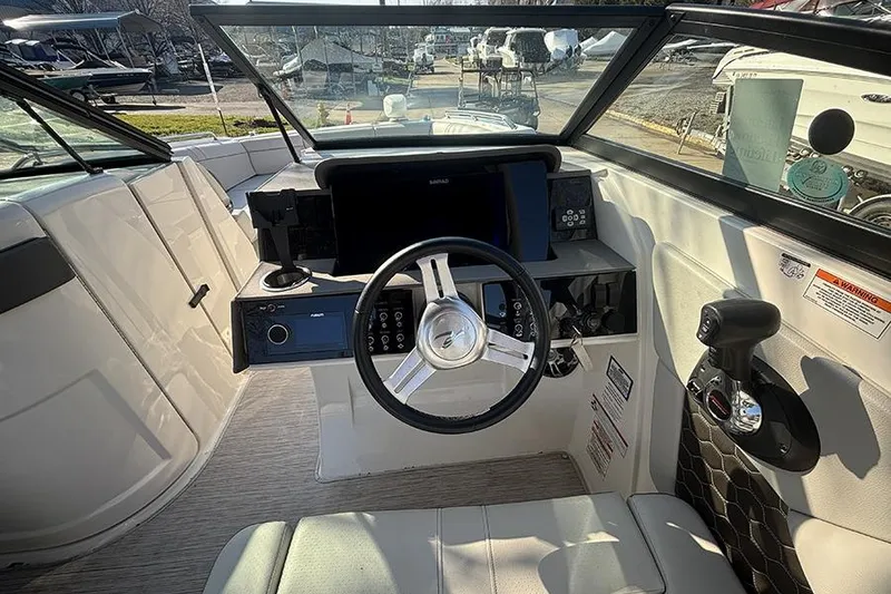 Slide: The Image of Cockpit of 2021 Sea Ray SDX 270 Outboard with steering wheel and control panel. - 21