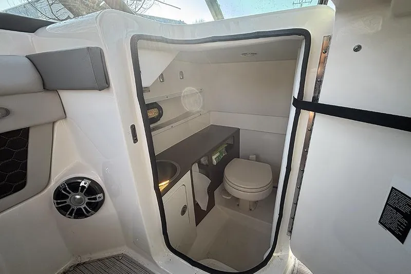 Slide: The Image of 2021 Sea Ray SDX 270 Outboard boat interior bathroom with sink and toilet. - 24