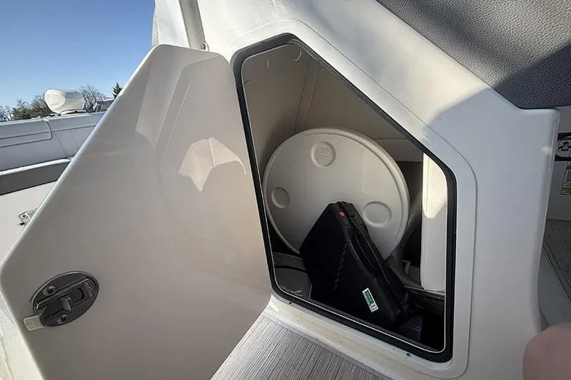 Slide: The Image of Storage compartment on a 2021 Sea Ray SDX 270 Outboard boat, open door view. - 26