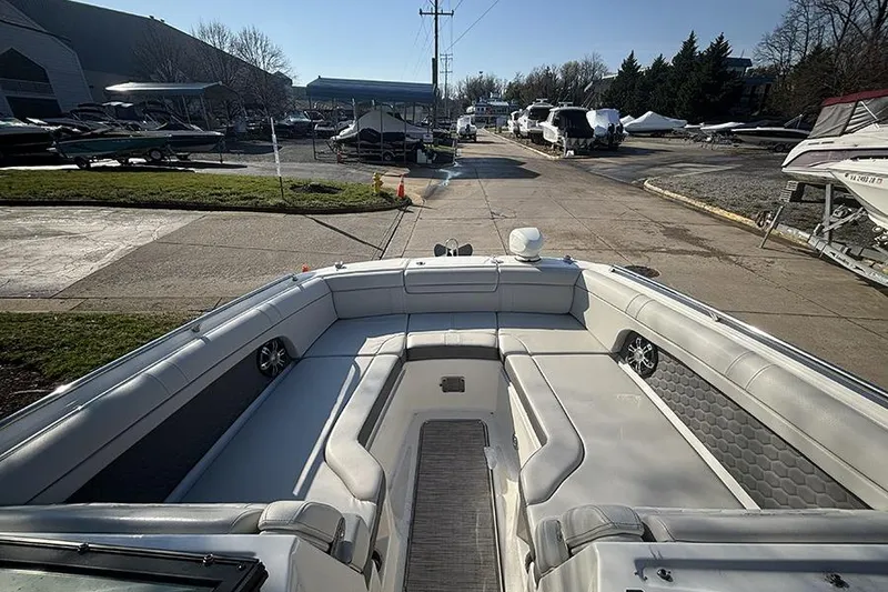Slide: The Image of 2021 Sea Ray SDX 270 Outboard boat interior with spacious seating at a marina. - 28