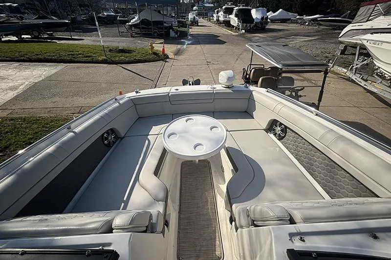 Slide: The Image of 2021 Sea Ray SDX 270 Outboard boat interior with seating and table, docked at marina. - 29