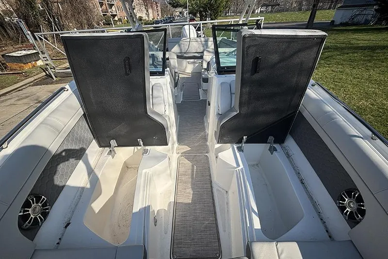 Slide: The Image of 2021 Sea Ray SDX 270 Outboard interior with open storage compartments and seating. - 32