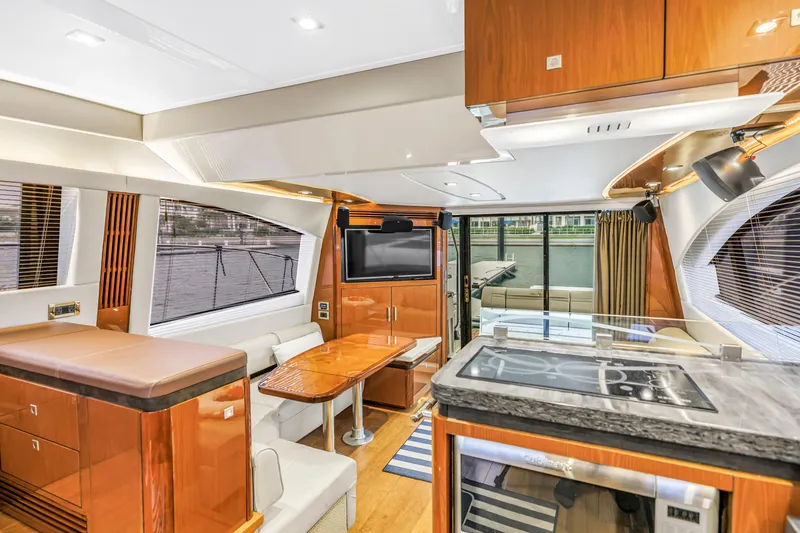 Slide: The Image of Luxurious interior of 2016 Sea Ray 510 Fly yacht with modern kitchen and seating area. - 17