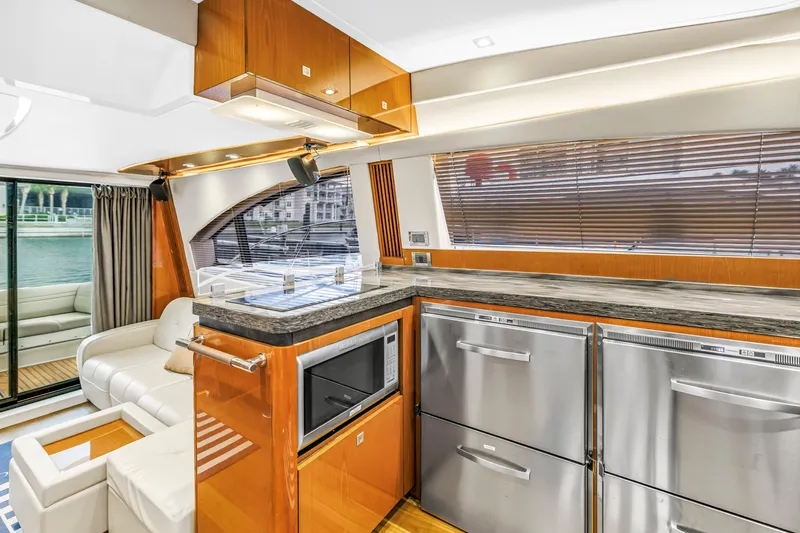 Slide: The Image of Luxurious interior of 2016 Sea Ray 510 Fly yacht with modern kitchen and seating area. - 18