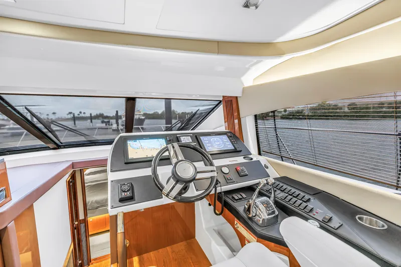 Slide: The Image of Helm of 2016 Sea Ray 510 Fly yacht with modern navigation controls and panoramic windows. - 20